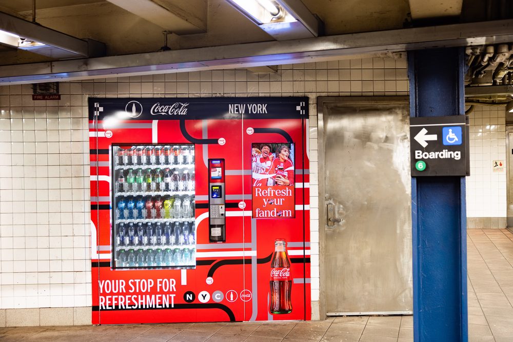 Automated retail machine in a tiled passageway at the Broadway-Lafayette Street subway station