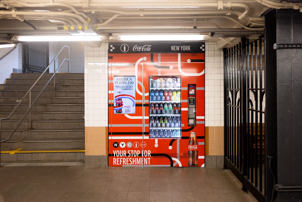 Automated retail machine beside a staircase at the Christopher Street-Stonewall subway station