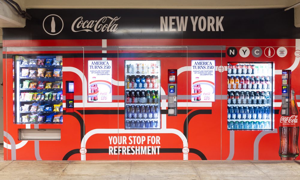 Coca-Cola-branded automated retail wall with snack and beverage vending machines and digital displays at the Second Avenue-East Houston subway station