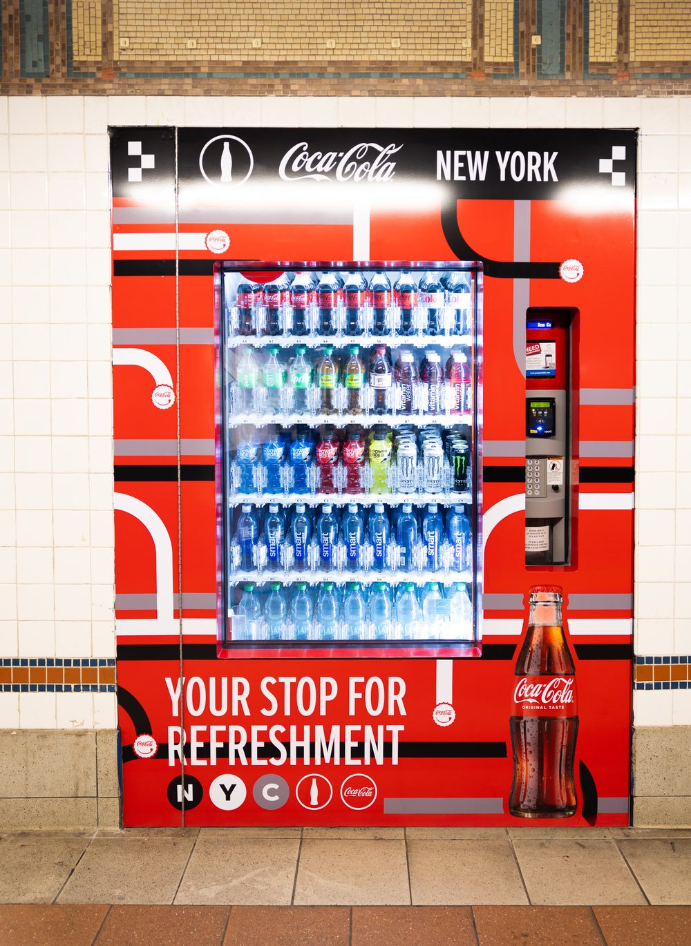 Automated beverage machine set into the tiled wall of the 8th Street-NYU subway station